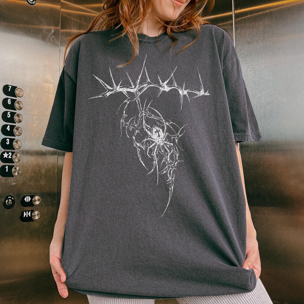 Dark gray oversized t-shirt featuring a graphic design of a spider within a thorny crown.
