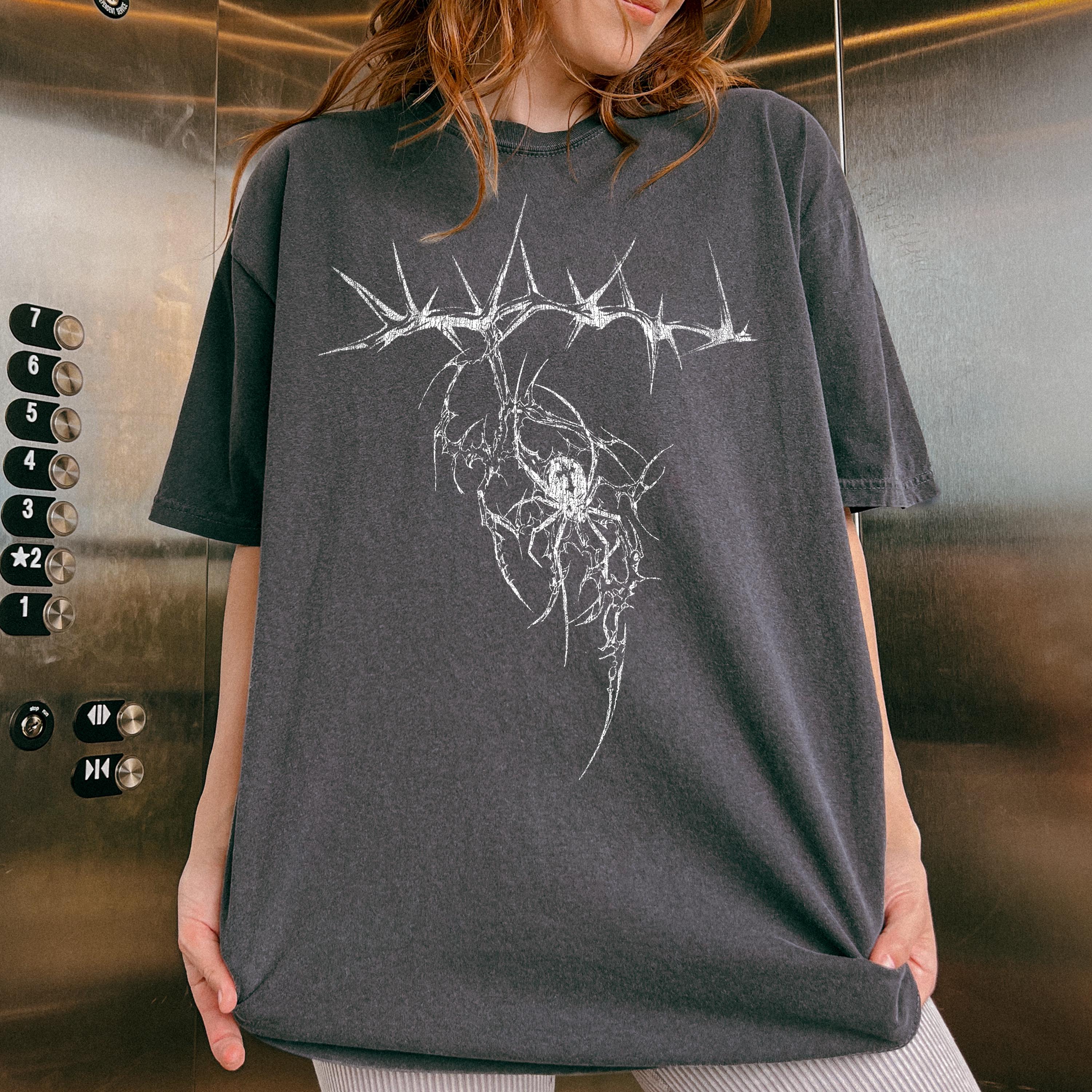 Dark gray oversized t-shirt featuring a graphic design of a spider within a thorny crown.